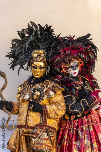 Italy, Venice, carnival 2019, typical masks, beautiful clothes, posing for photographers and tourists.