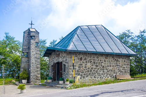 mountain church with stone bell tower photo