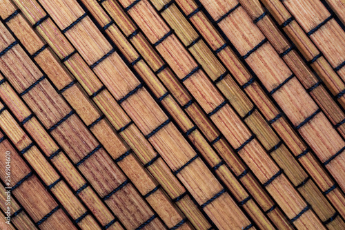 Dry bamboo texture in the form of small rectangles (collection of vegetable and natural fibers). Foreground.