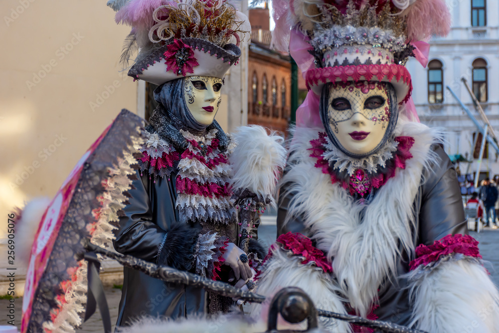 Italy, Venice, carnival 2019, typical masks, beautiful clothes, posing for photographers and tourists.
