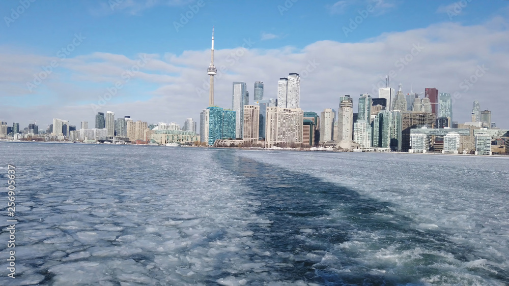 View of Toronto city skyline form a boat as it crosses the frozen Lake Ontario