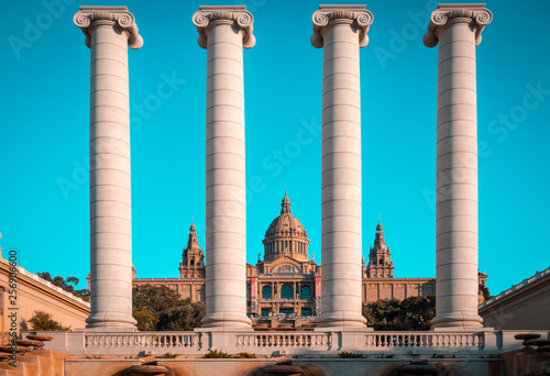 The Four Columns are an iconic columns originally created by Josep Puig i Cadafalch near Palau Nacional now National Art Museum in barcelona, Spain. Teal and orange style. photo