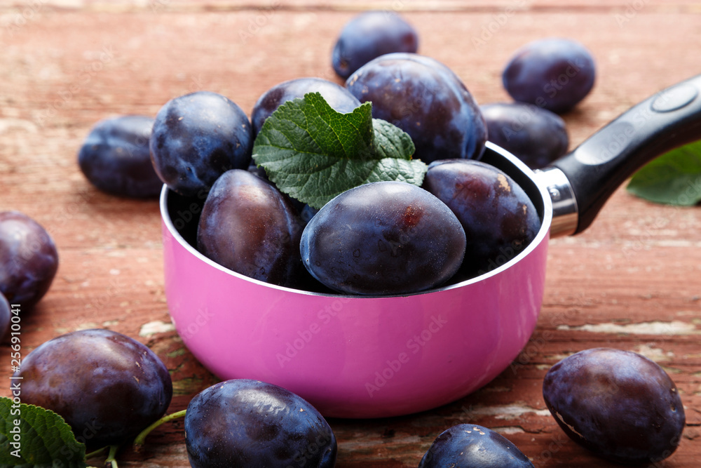 ripe plums in a saucepan on the table ripe plums in a saucepan on the table