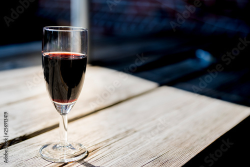 glass of red port, on wooden table, space for text