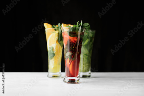 Close up photo selection of cocktails with mint, orange,lime on white and black background indoor. top view