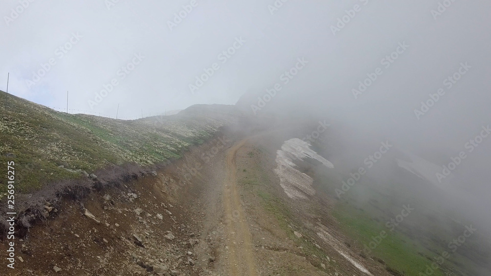 Road in clouds high in the mountains