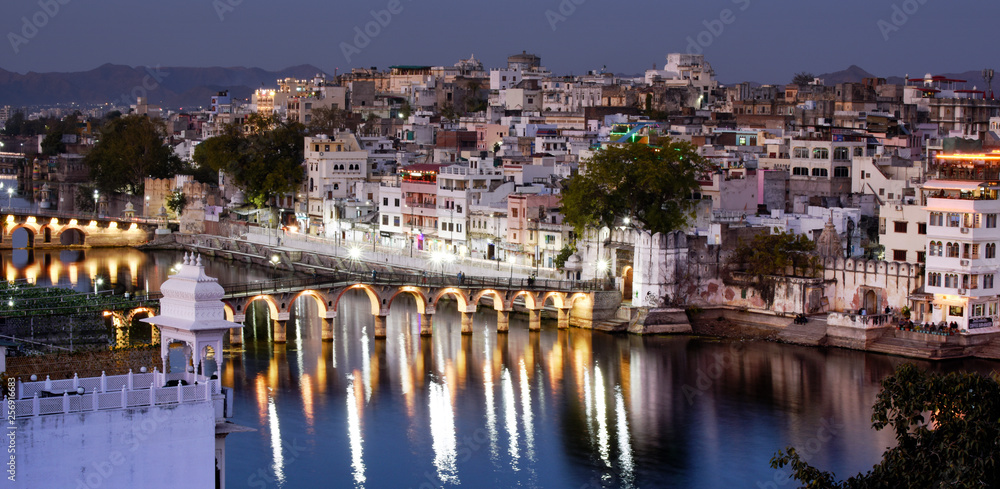 city view with lake pichola and Chand Pole Puliya bridge by night, Udaipur, Rajasthan, india