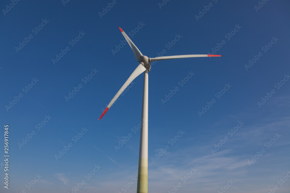wind turbine with sun flare blue sky background view from below wind turbine with sun flare blue sky background view from below