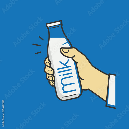Hand hold milk bottle. Male hand holding a milk