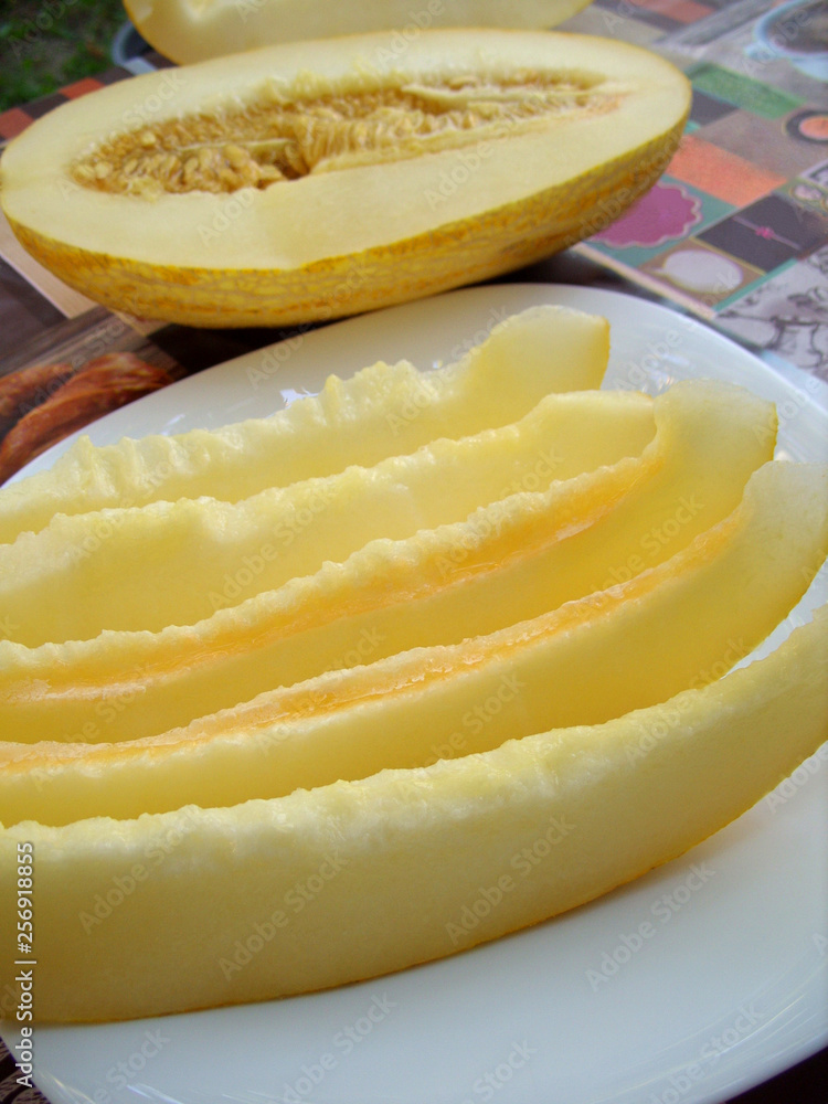 ripe melon on a plate of slices ripe melon on a plate of slices