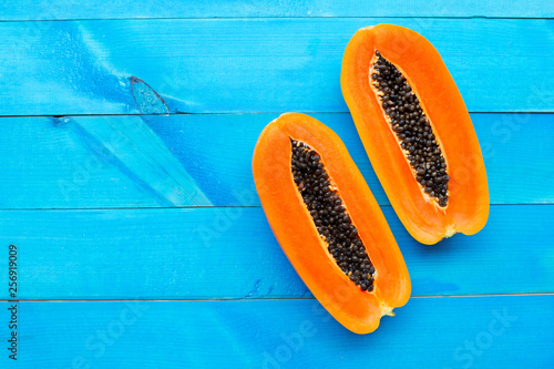 Papaya fruit on blue wooden background