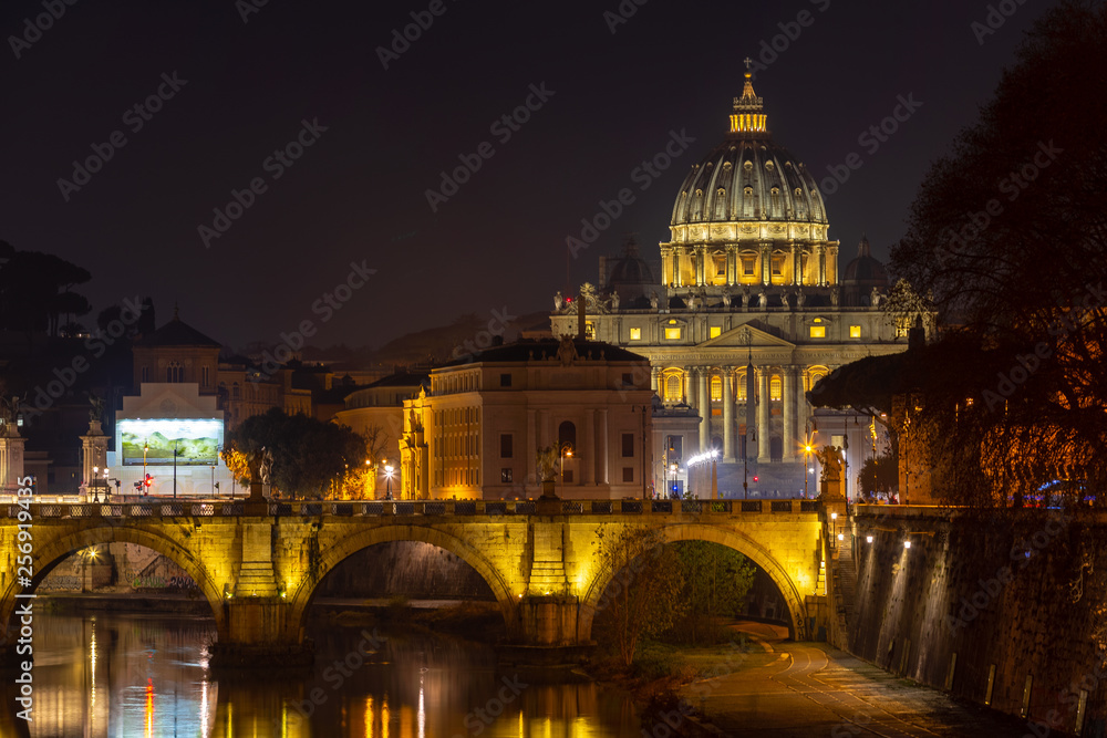 St Peter's Basilica at night view from bridge over Tiber