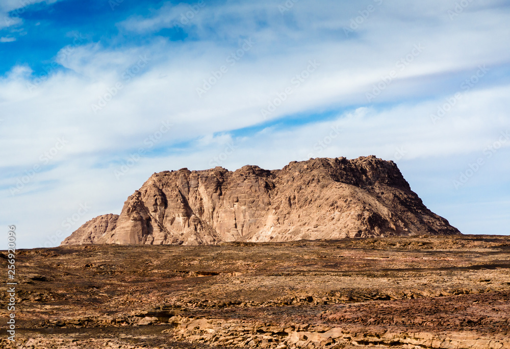 high mountain in the desert against the blue sky and white clouds in Egypt Dahab South Sinai high mountain in the desert against the blue sky and white clouds in Egypt Dahab South Sinai