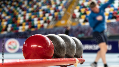 Rear view sportsman practising shot put against view of a stadium photo