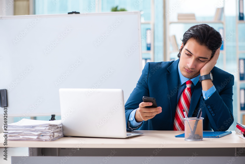 Young handsome businessman in front of whiteboard Young handsome businessman in front of whiteboard