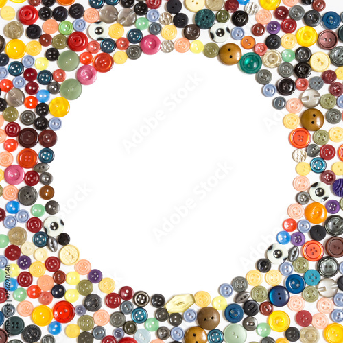 background with round frame - multicolored buttons on a white surface