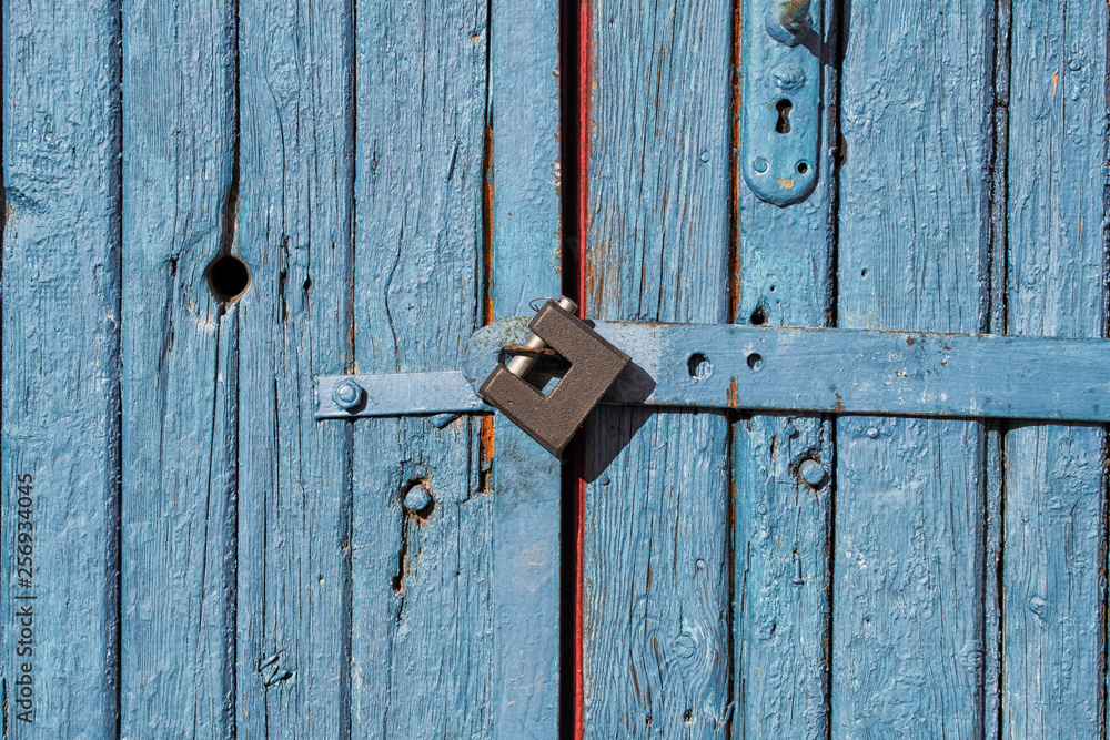 Padlock on old wooden doors Padlock on old wooden doors
