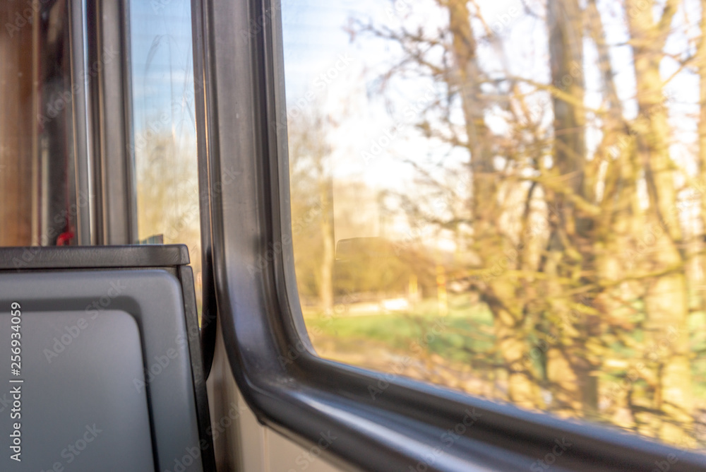 Seat window on the train and view of countryside, field and nature through window. Enjoy outdoor scenery moment during journey and travel by train. 