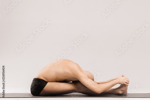 Man  figures doing yoga asanas. Yogi poses. A man makes a complex figure of yoga. Extremely difficult asanas in yoga. Asanas.