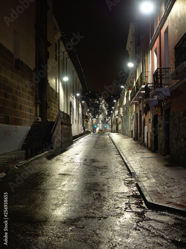 A street in the historic center on a rainy night  Quito  Ecuador.