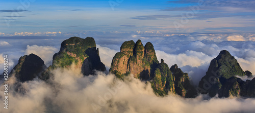 Chinese Karst Mountains above the clouds, steep cliffs covered in exotic trees. Dayao Mountain range near Jinxiu City, Guangxi Province China. Shengtang Mountain, Shengtangshan. Hiking and Travel photo
