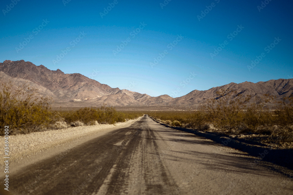 Empty desert road leading to mountains Empty desert road leading to mountains