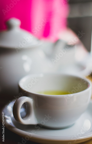 Cup of tea with teapot, cup of green tea.