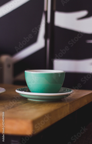 Black coffee in blue cup on wooden background, filter coffee. 
