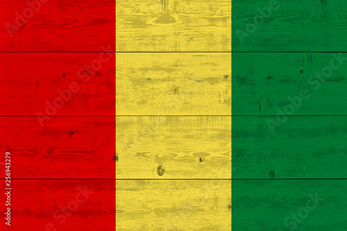 Guinea flag painted on old wood plank © Visual Content