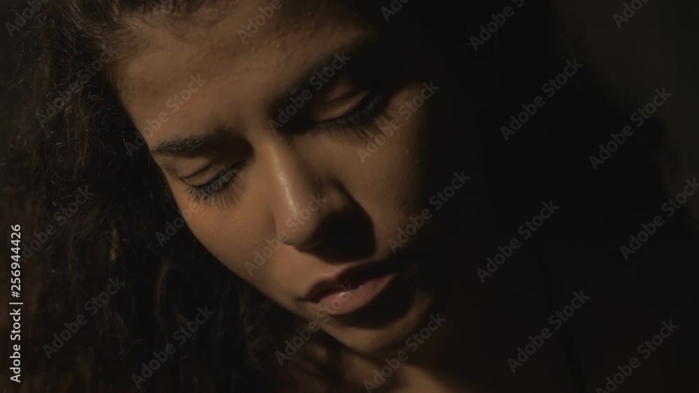 depressed attractive young woman with closed eyes alone in the dark depressed attractive young woman with closed eyes alone in the dark