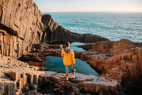 adventurous man on the cliffs enjoying the landscape
