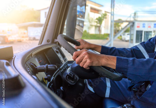 Truck driver keeps driving with hands,The man Behind Semi Truck Steering Wheel.