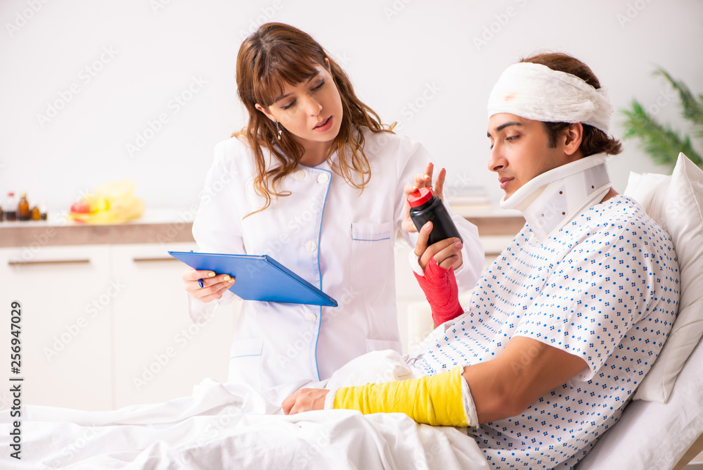 Young doctor examining injured patient Young doctor examining injured patient