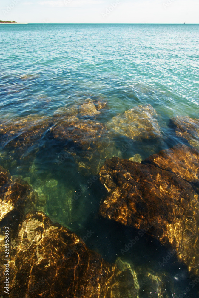 Lake Michigan as seen from the shore in Chicago, showing rock at the bottom through the clear water.