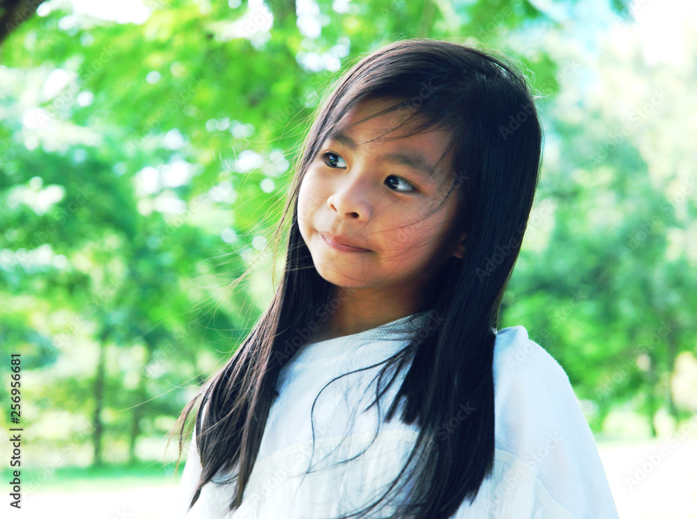 Beautiful Asian kid girl smile portrait and walking in the public park on holiday weekend. Beautiful Asian kid girl smile portrait and walking in the public park on holiday weekend.