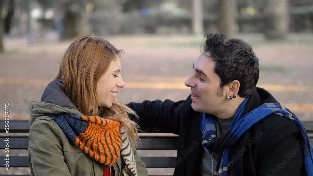 First date in the park. young man refuse kissing, gently woman First date in the park. young man refuse kissing, gently woman