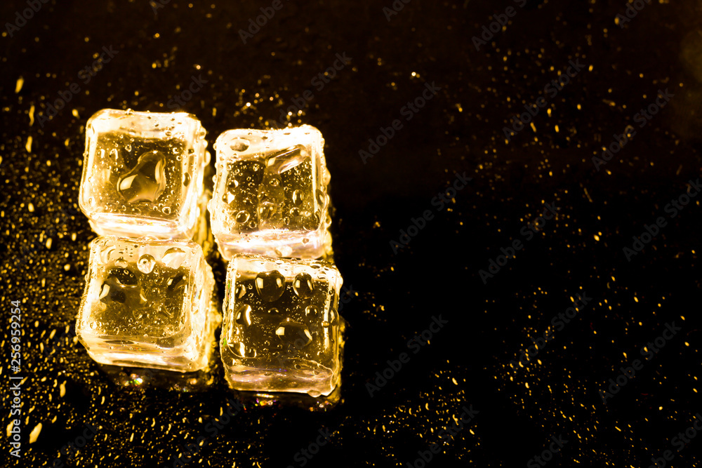 ice cubes and water drop on light golden background. ice cubes and water drop on light golden background.