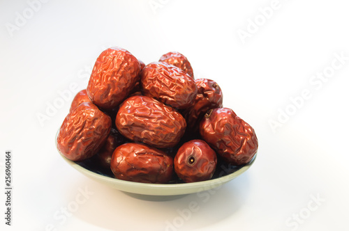 dried dates in a bowl isolated on white background