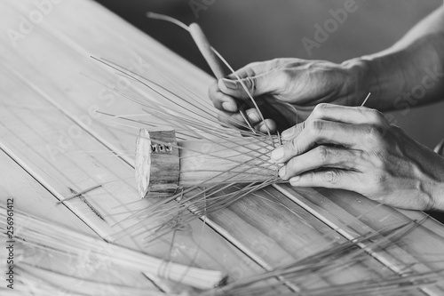 closeup asian worker hand making handicraft weave basket black and white art tone.