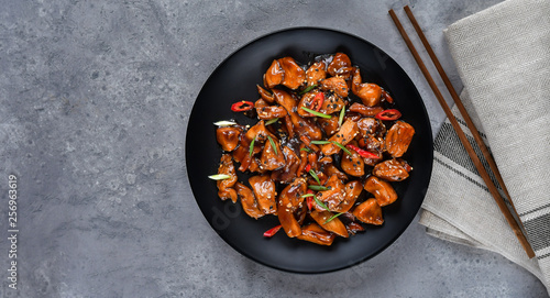 teriyaki chicken's with sesame seeds. spicy chicken in sweet and sour sauce with chili pepper. Chinese cuisine, copy space, recipe background, food flat lay, menu of japanese restaurant