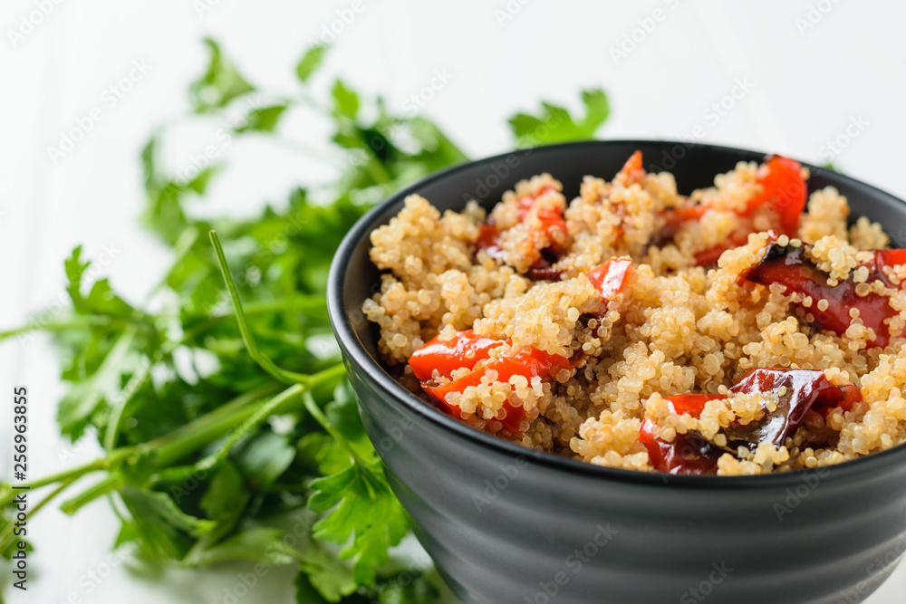 Parsley greens with a bowl of quinoa salad and baked vegetables. Vegetarian dish. Parsley greens with a bowl of quinoa salad and baked vegetables. Vegetarian dish.