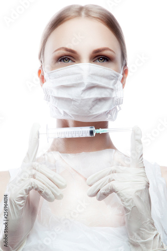 Portrait woman nurse, beautician or doctor wearing medical protective mask and gloves hold injection syringe in hands. White background