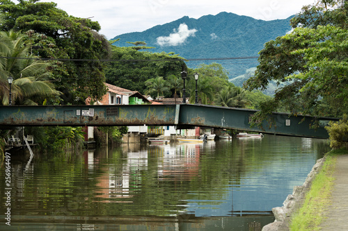 Panoramic colorful view of the city of Paraty  Brazil  near the river  with a metalic bridge.