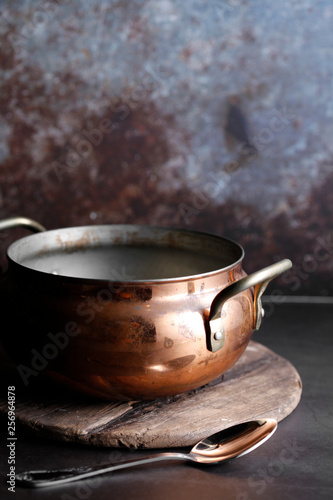 ancient moroccan soup pot on wooden tray