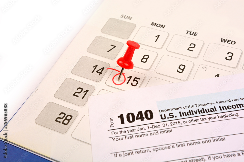 Red pushpin in calendar on 15th April for US tax day Red pushpin in calendar on 15th April for US tax day