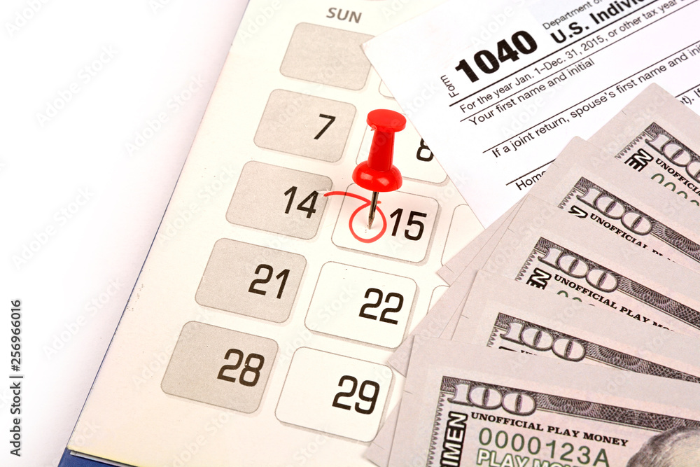 Red pushpin in calendar on 15th April for US tax day Red pushpin in calendar on 15th April for US tax day
