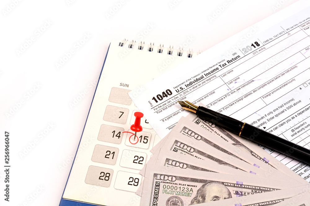 Red pushpin in calendar on 15th April for US tax day Red pushpin in calendar on 15th April for US tax day
