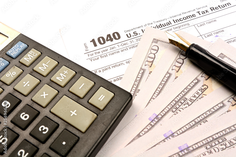 Calculating US tax with 1040 tax form on white background Calculating US tax with 1040 tax form on white background