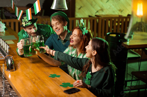 Company of good friends celebrating st.patricks day in the irish pub