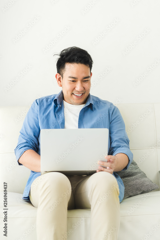 Asian man using laptop at home, lifestyle concept with copy space. Asian man using laptop at home, lifestyle concept with copy space.